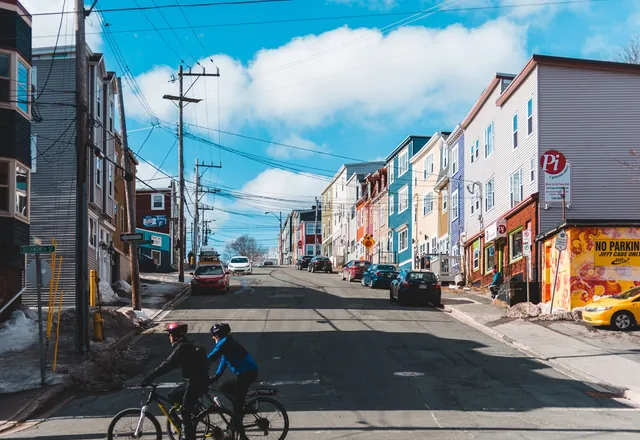 Two cyclists riding along a city street