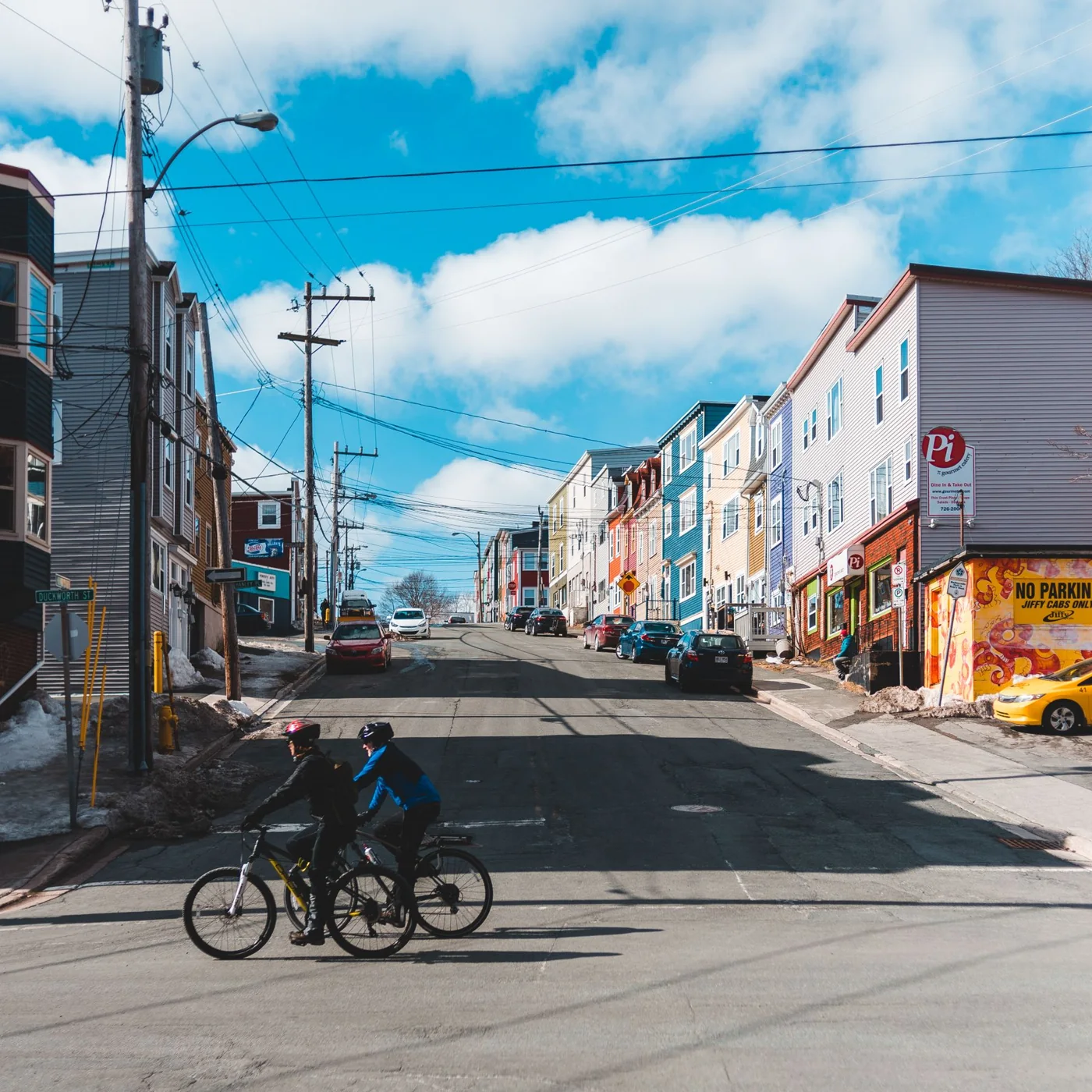 Two cyclists riding along a city street