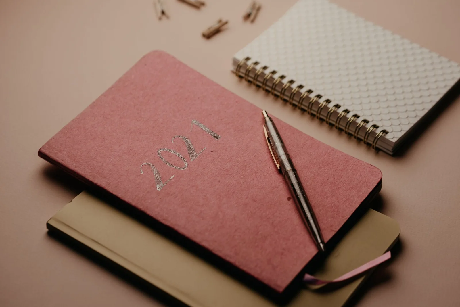Notebooks and a pen arranged on a table