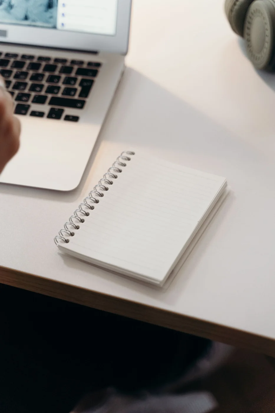 A notebook and laptop on a desk