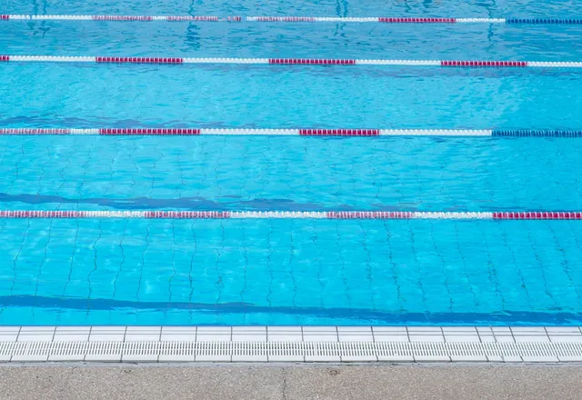 An outdoor swimming pool with marked lanes