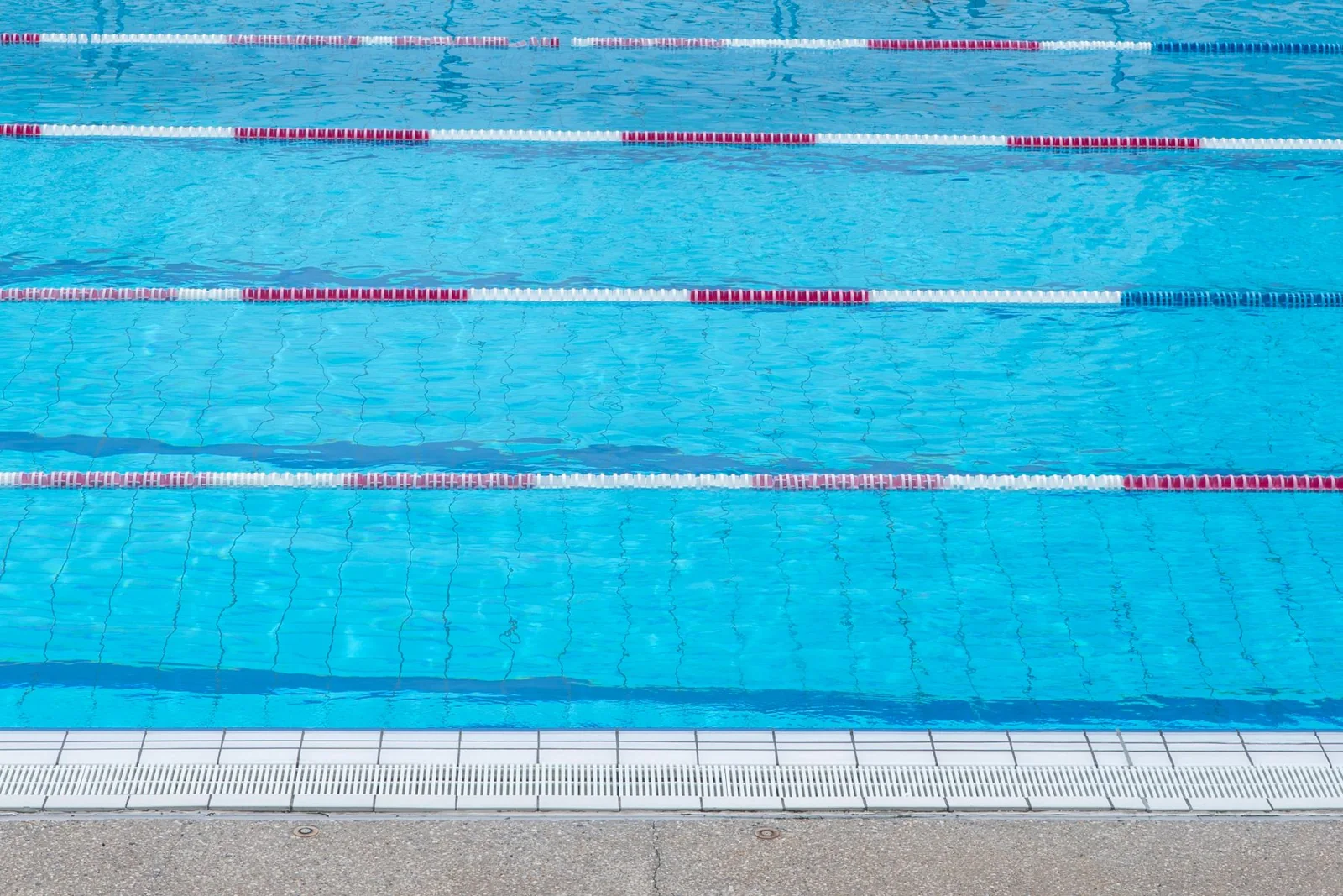 An outdoor swimming pool with marked lanes